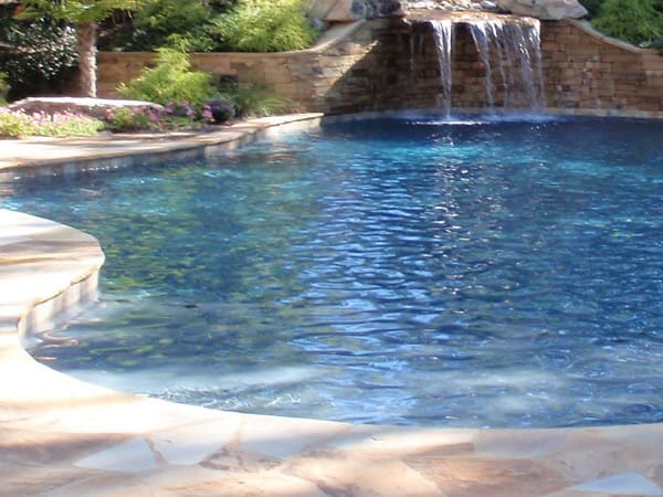 Clear blue pool water with a stone edge